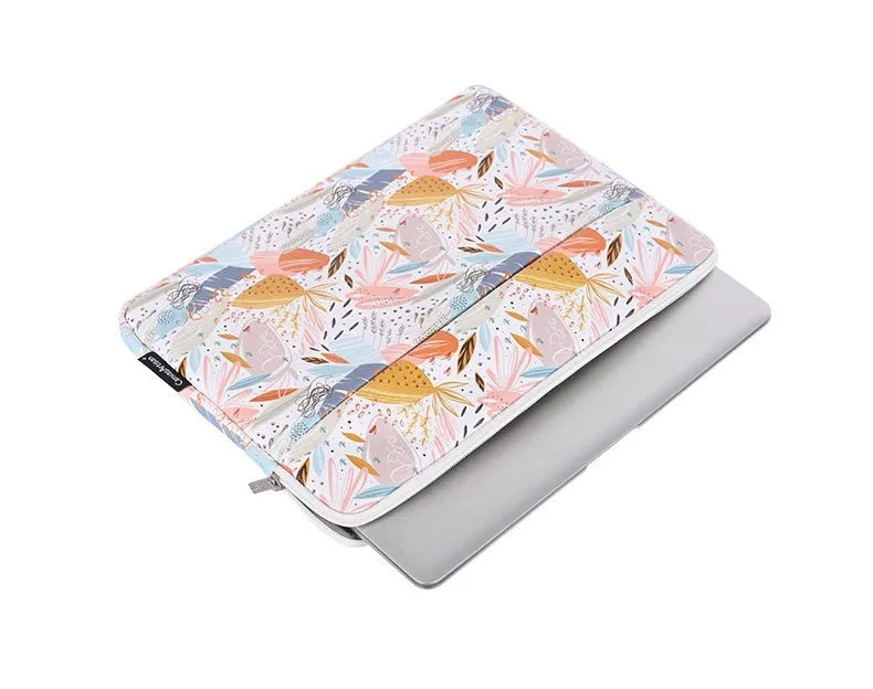 White waterproof PU leather laptop sleeve for 11 to 15 inch computers on a table.