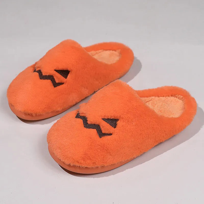 Orange pumpkin-themed plush slippers with a non-slip sole for indoor home wear.