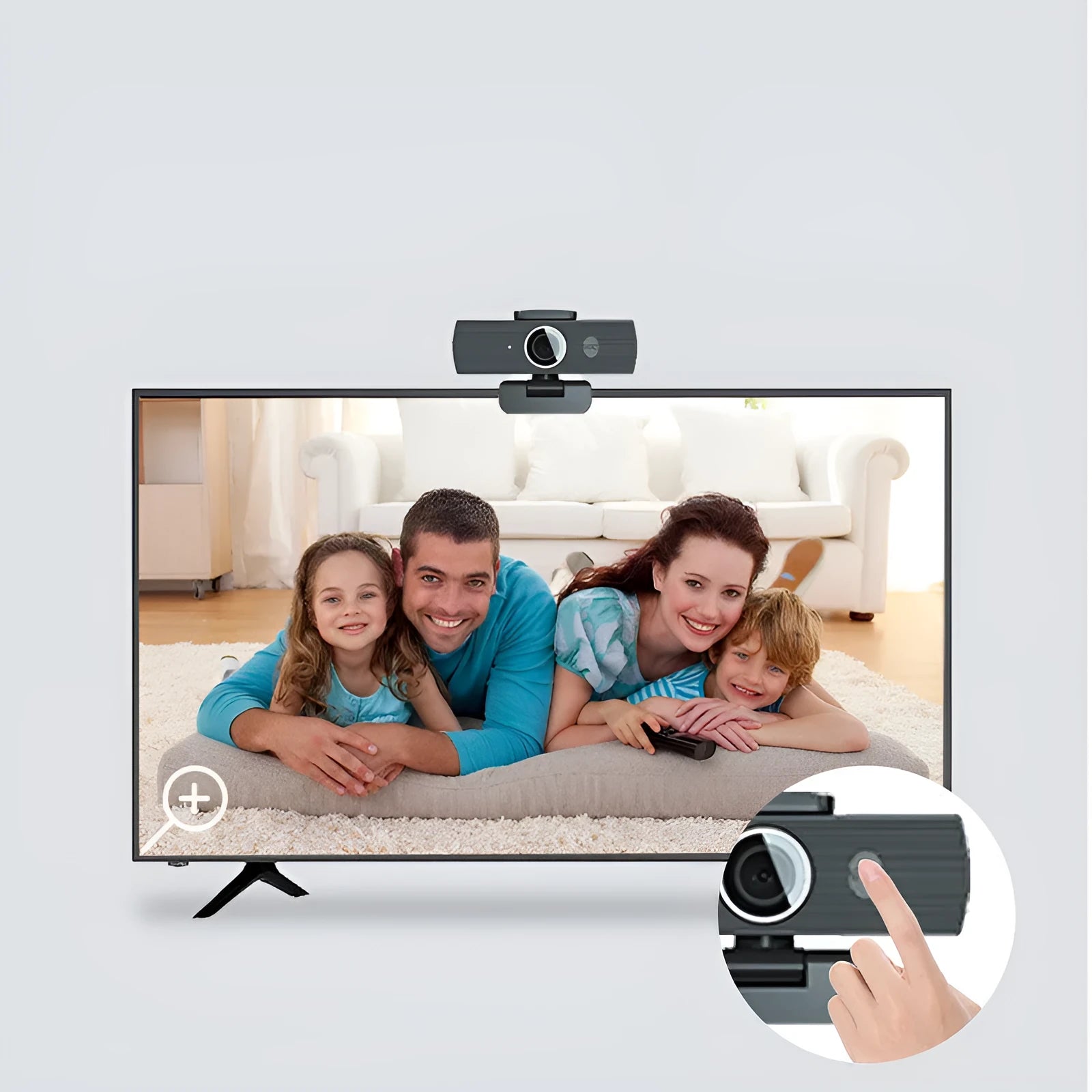 Black USB webcam with magnetic privacy cover on desk next to computer monitor