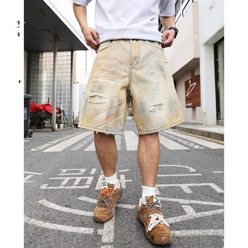 Men's light blue denim shorts with ripped detailing and a straight-leg cut.