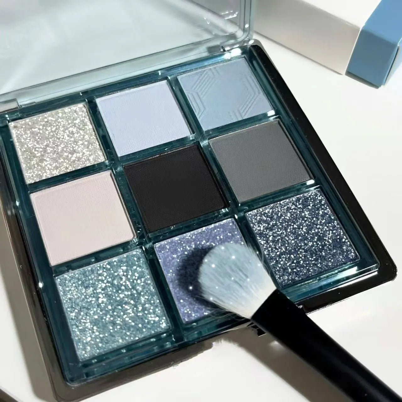 MUGELEEN nine-colour eye shadow palette showing blue smoked and earth tone shades