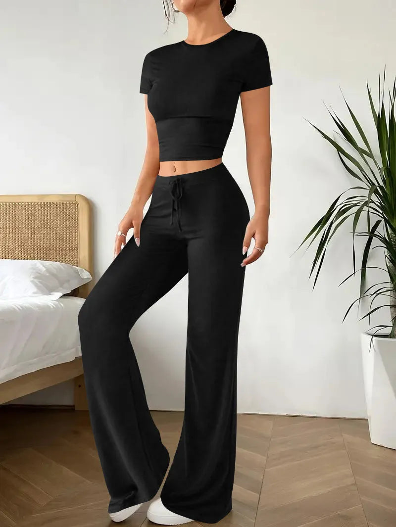 Black high-waist trousers and short sleeve t-shirt co-ord set for women.