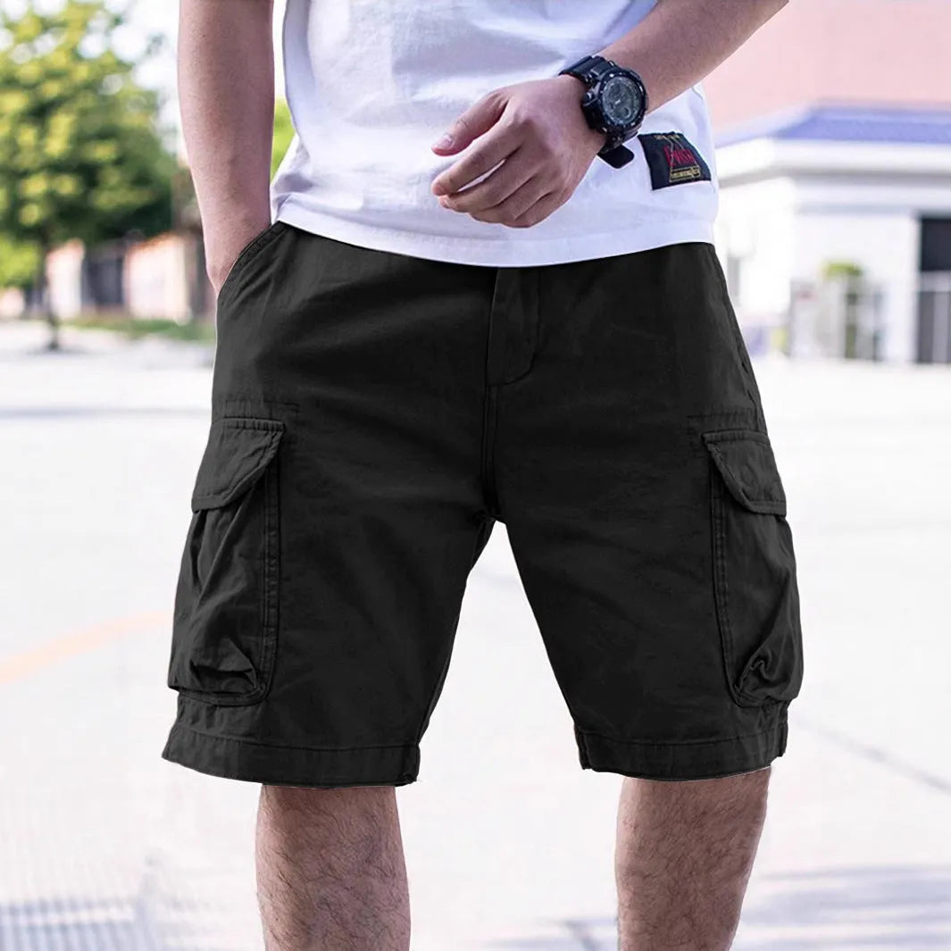 Man wearing loose-fit army green cotton blend workwear shorts with an elastic waist.