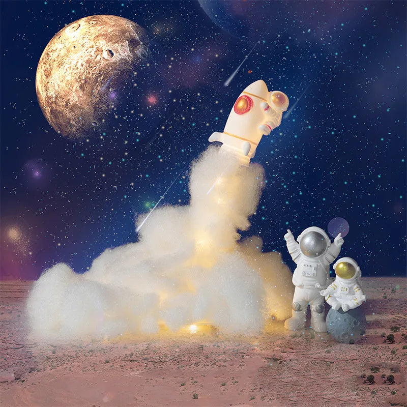 DIY astronaut rocket night light kit with LED string lights, small model, and straws for assembly on a desk.