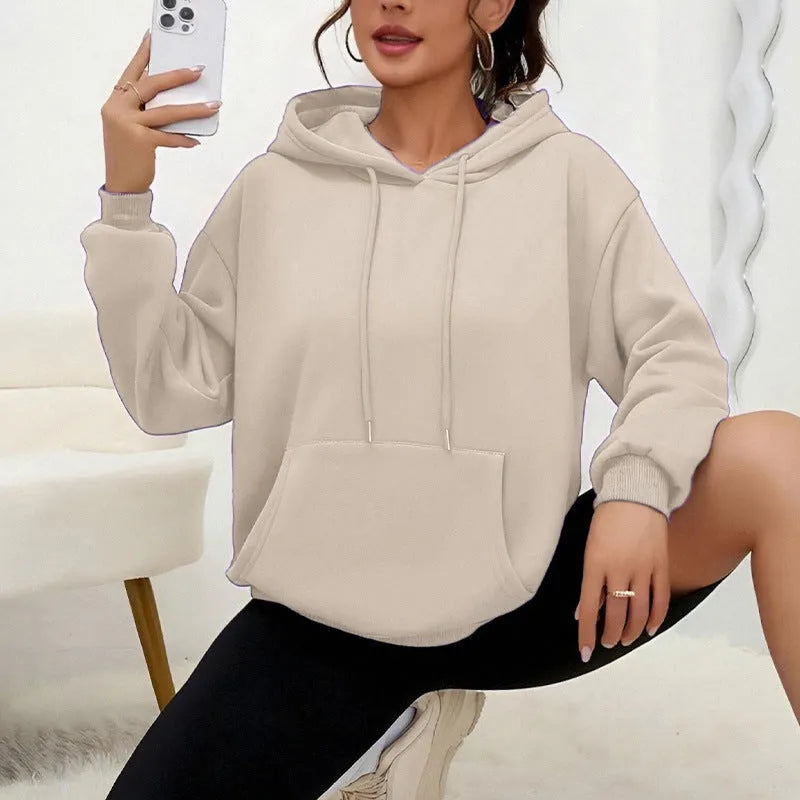 A loose-fitting women's long-sleeve sweatshirt with a drawstring pocket, shown in a solid colour.