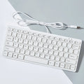 Compact black wired USB keyboard with noiseless keys on a desk.