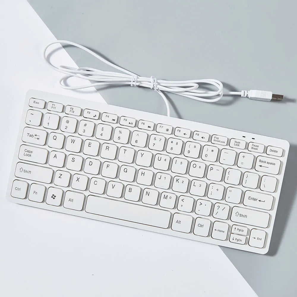 Compact black wired USB keyboard with noiseless keys on a desk.