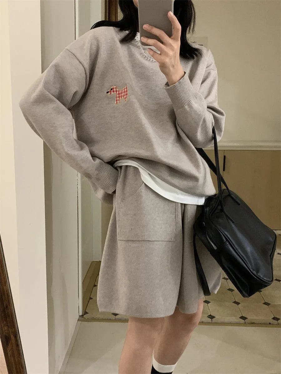Women's milk blue casual knitted sports suit with animal embroidery on top and matching shorts.