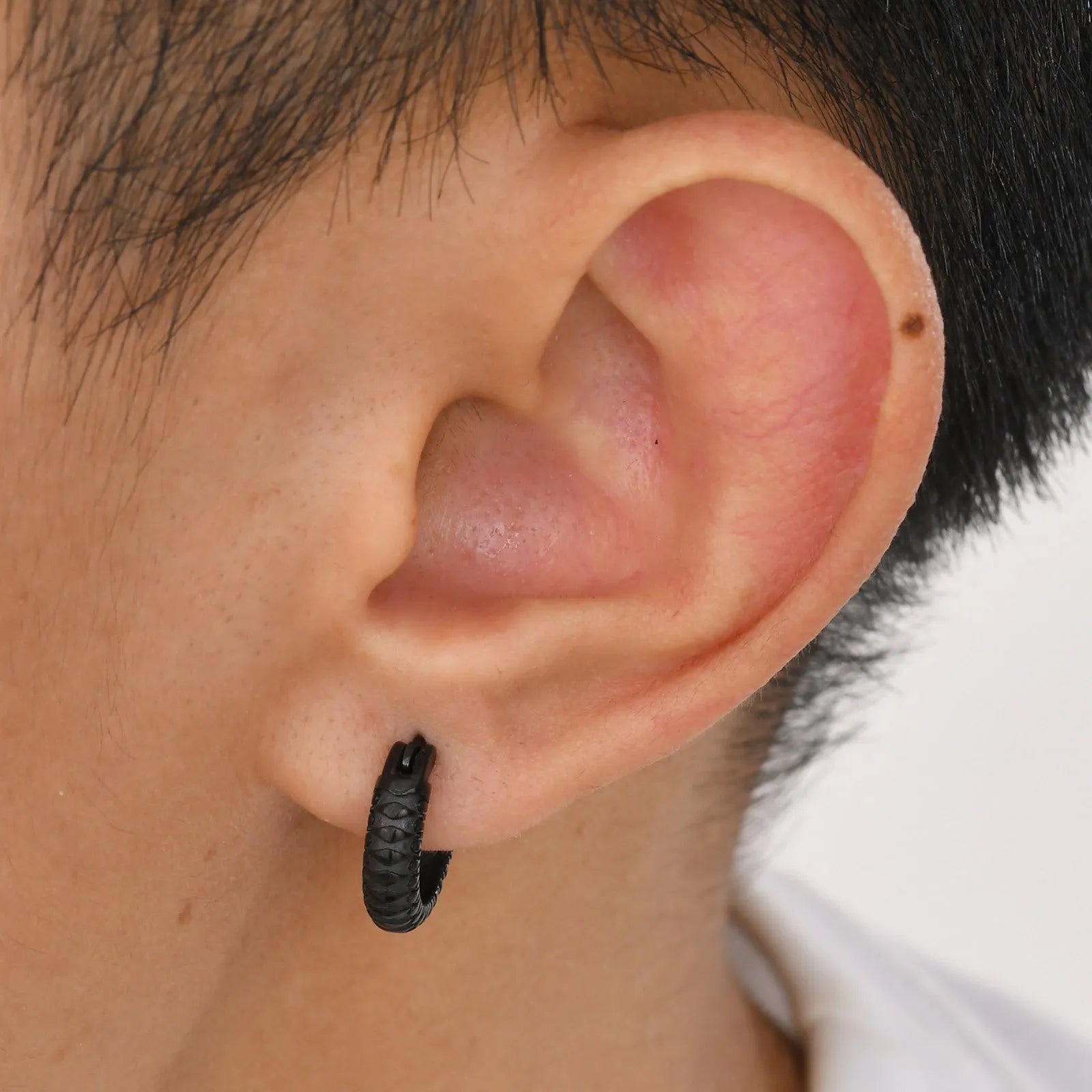 Stainless steel snake pattern earrings with butterfly clip fastening in black or gold finish