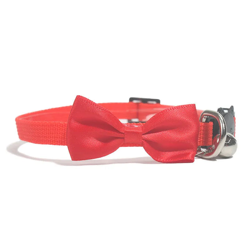 Adjustable nylon cat collar with decorative bow and bell in multiple colour options including red, blue, pink and green