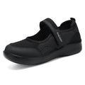 Women's grey mesh slip-on casual shoes with Velcro strap fastening on a flat sole.