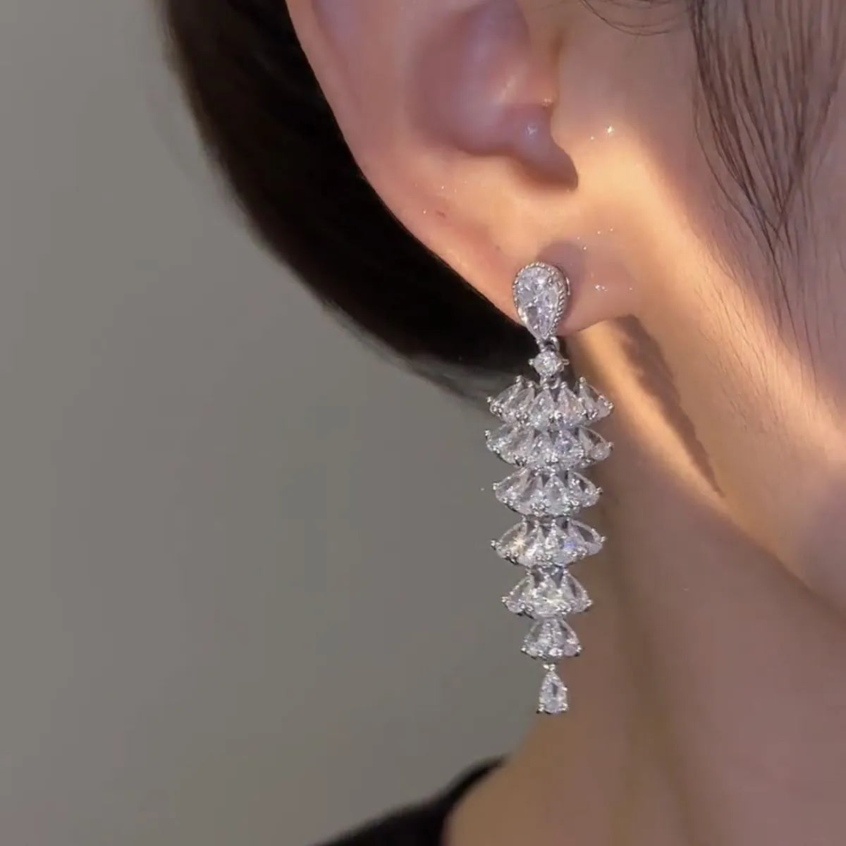 Silver pagoda Christmas tree drop earrings with sparkling zircon crystals on copper studs.