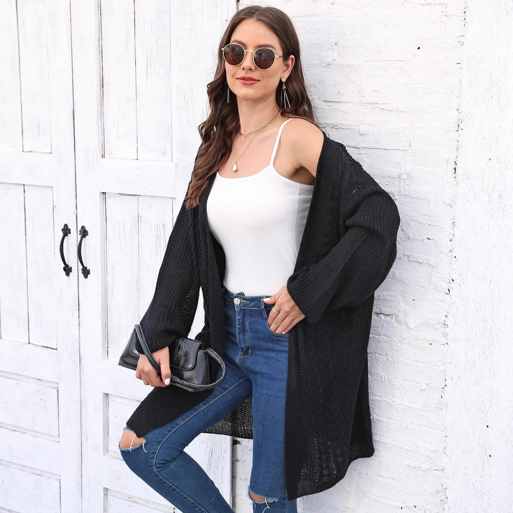 Women's loose brown acrylic sweater coat hanging on a hanger