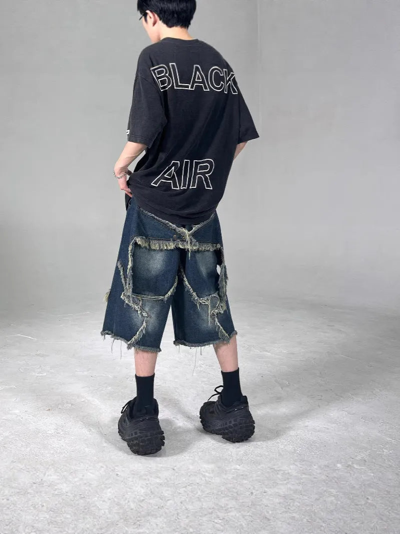 Blue denim shorts with five-pointed star detailing and frayed edges in loose fit style