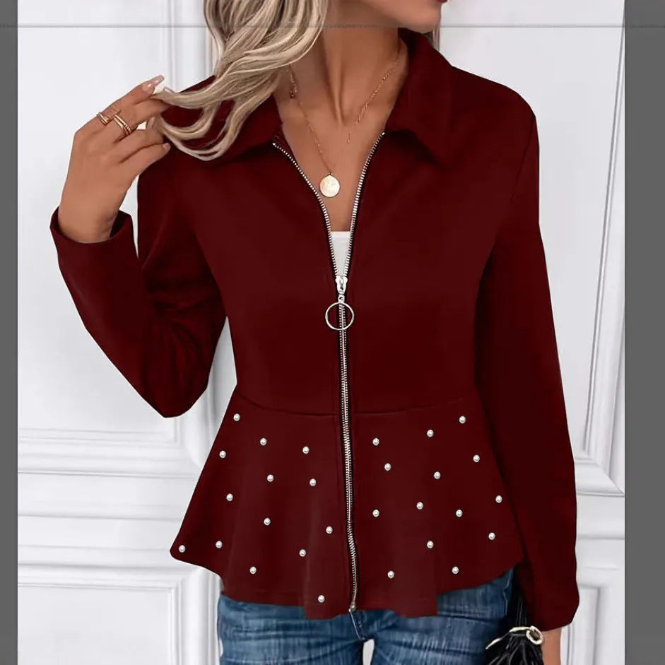 Women's loose black coat with beaded zipper and ruffled hem, shown on a hanger.