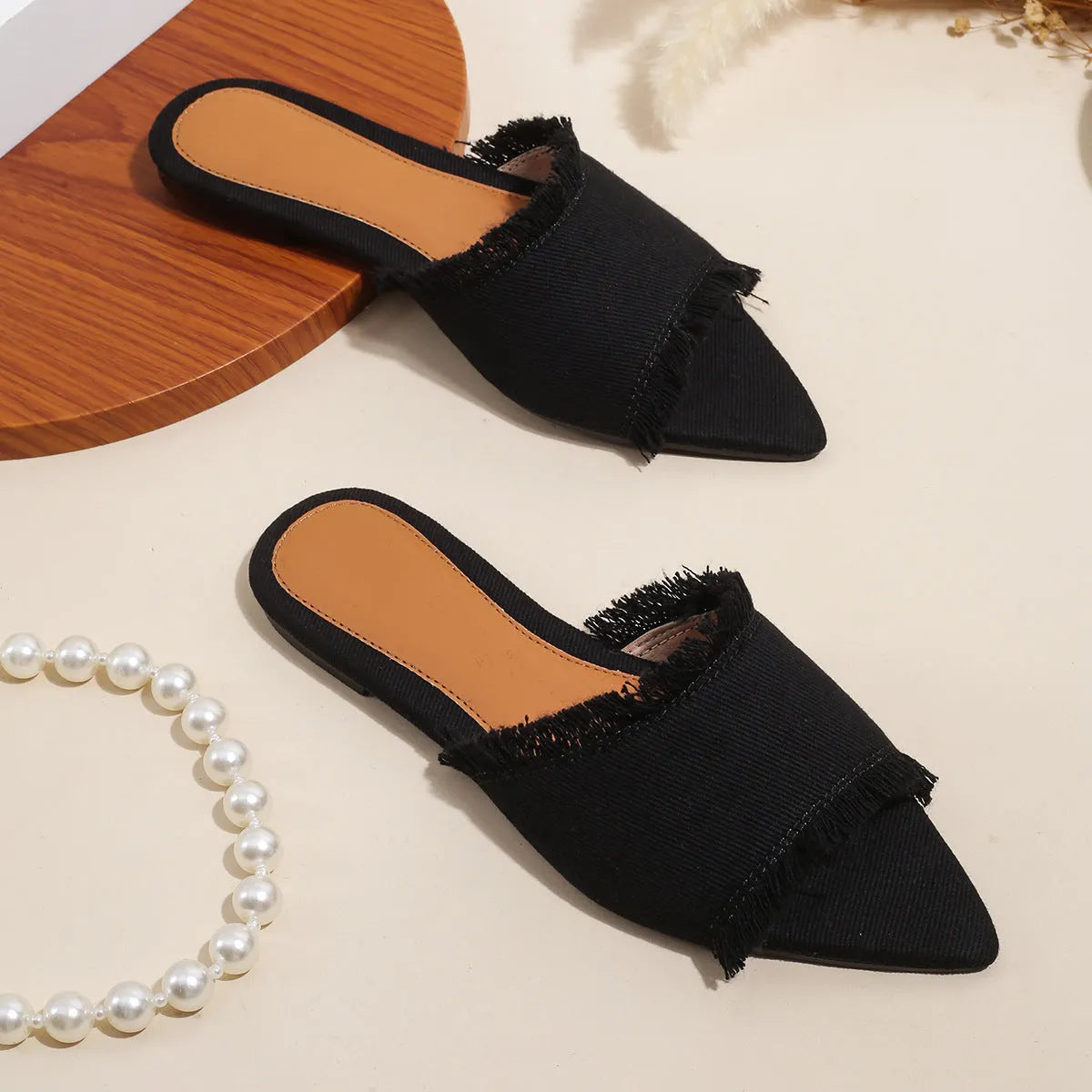 Women's denim flat slippers with tassel detail in multiple colour options showing leather lining and PVC sole