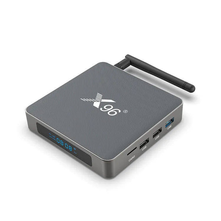 Android smart TV set-top box with voice remote control on a wooden table.