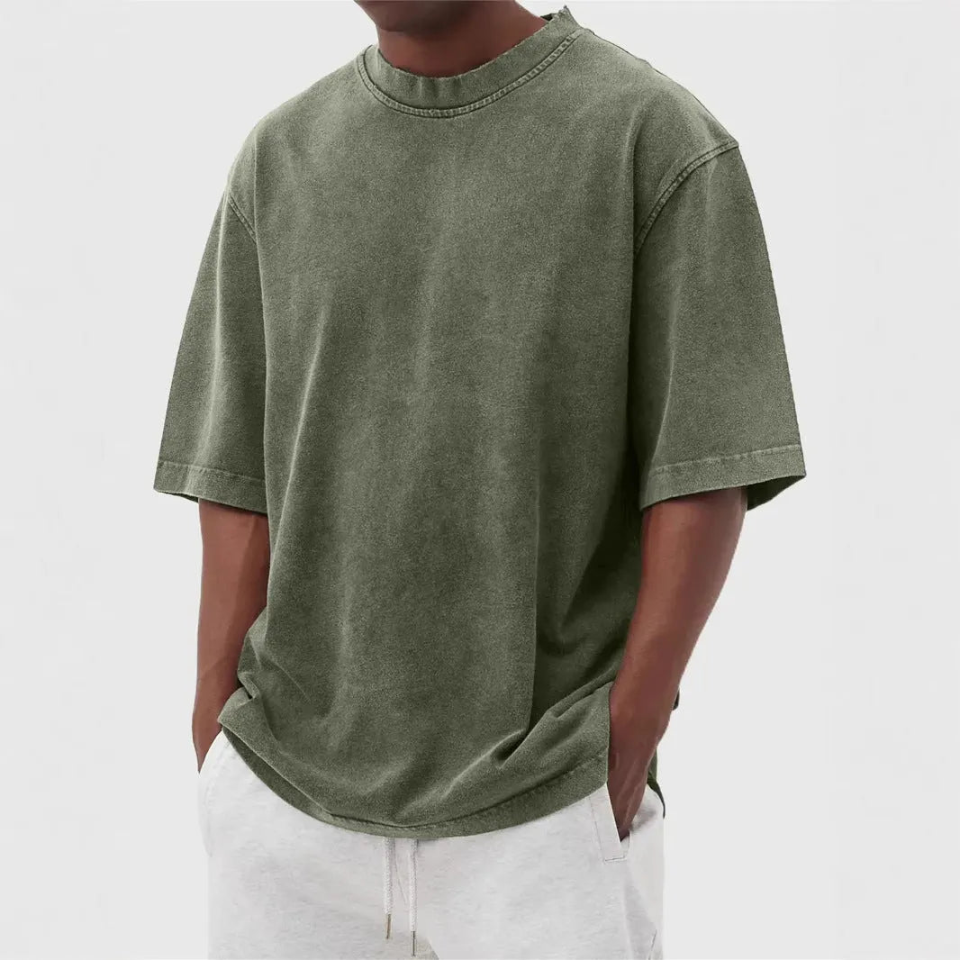 Men's loose fit pullover T-shirt in a stone-washed distressed solid colour, shown in army green.