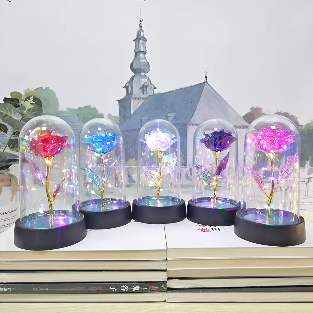 Small decorative night lamp with coloured plastic flower cover and black base on a table.