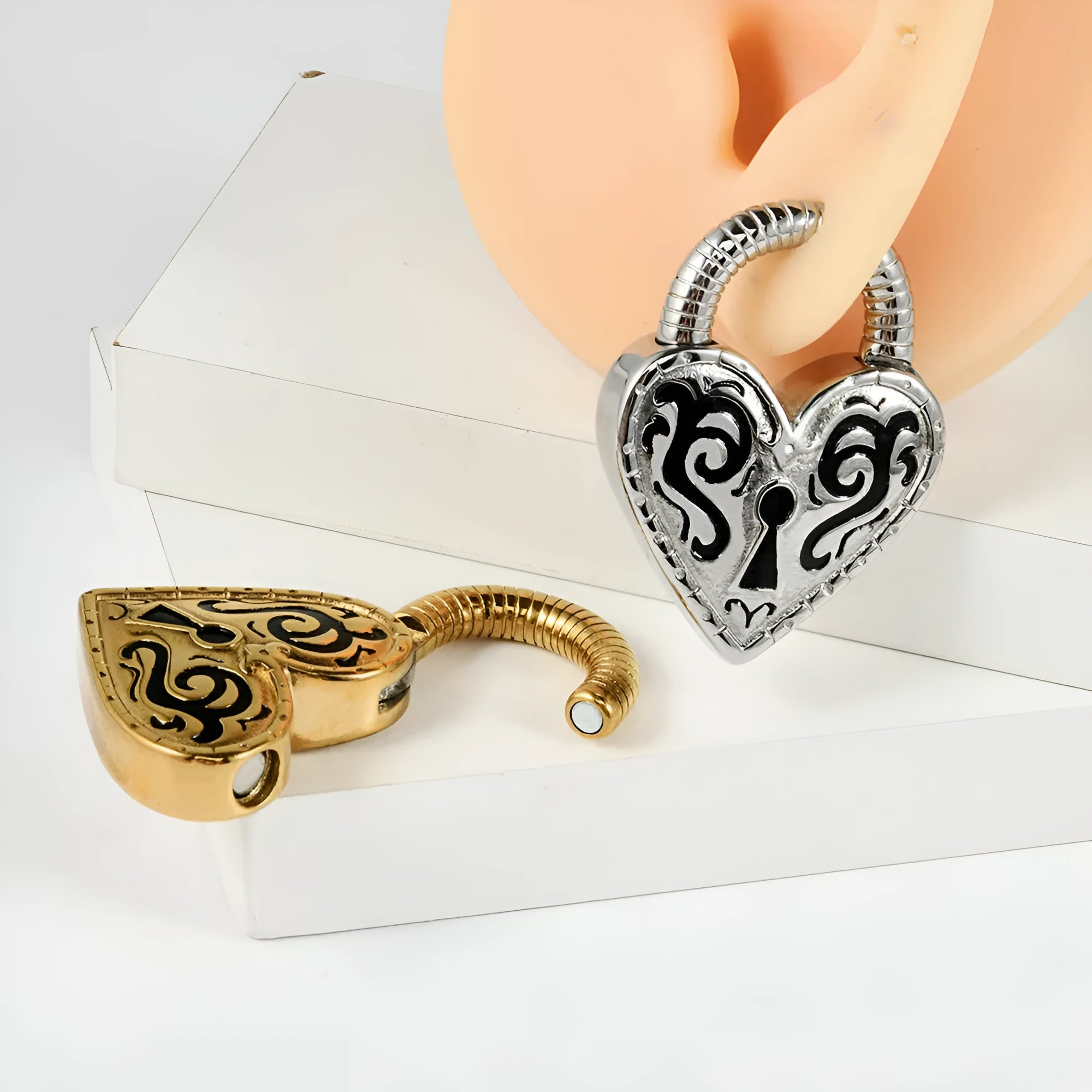 Women's stainless steel heart-shaped ear piercing studs in gold or steel colour options