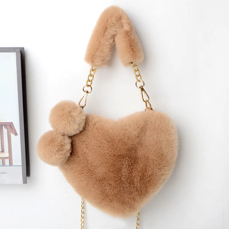A soft plush heart-shaped women's handbag with a zipper and a detachable shoulder strap in a choice of 14 colours.