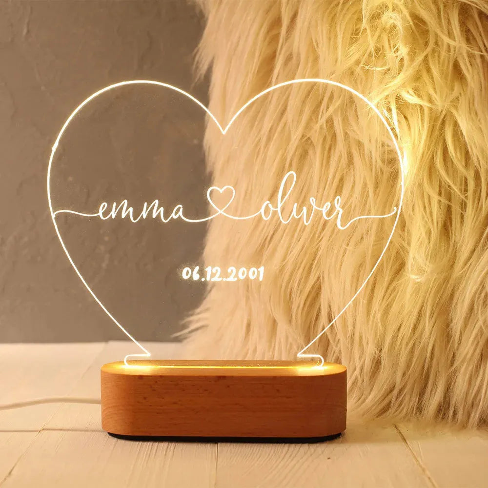 Custom transparent acrylic night light engraved with names, lit by LED base, dimensions 20cm by 11.5cm.