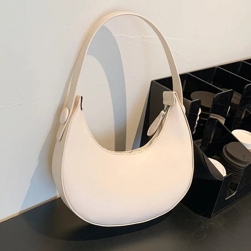 Women's retro dumpling-shaped shoulder bag in PU leather with a sandwich pocket.