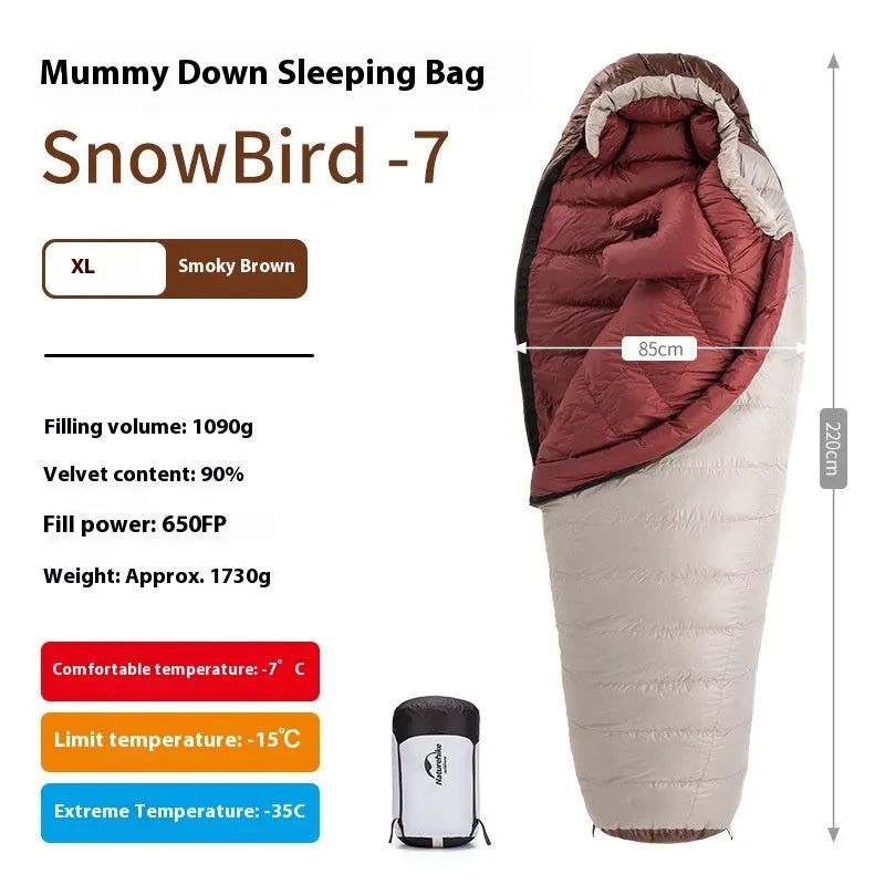 Adult mummy-style sleeping bag with goose down insulation shown with its storage bag.