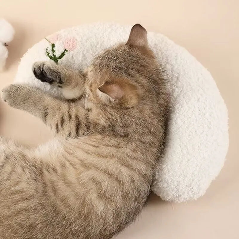 Blue U-shaped cloth pet sleeping mat for cats with neck support pillow in a question mark design.