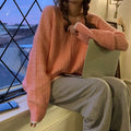 A woman's loose-fitting solid colour retro pullover sweater in lake blue, shown on a hanger.