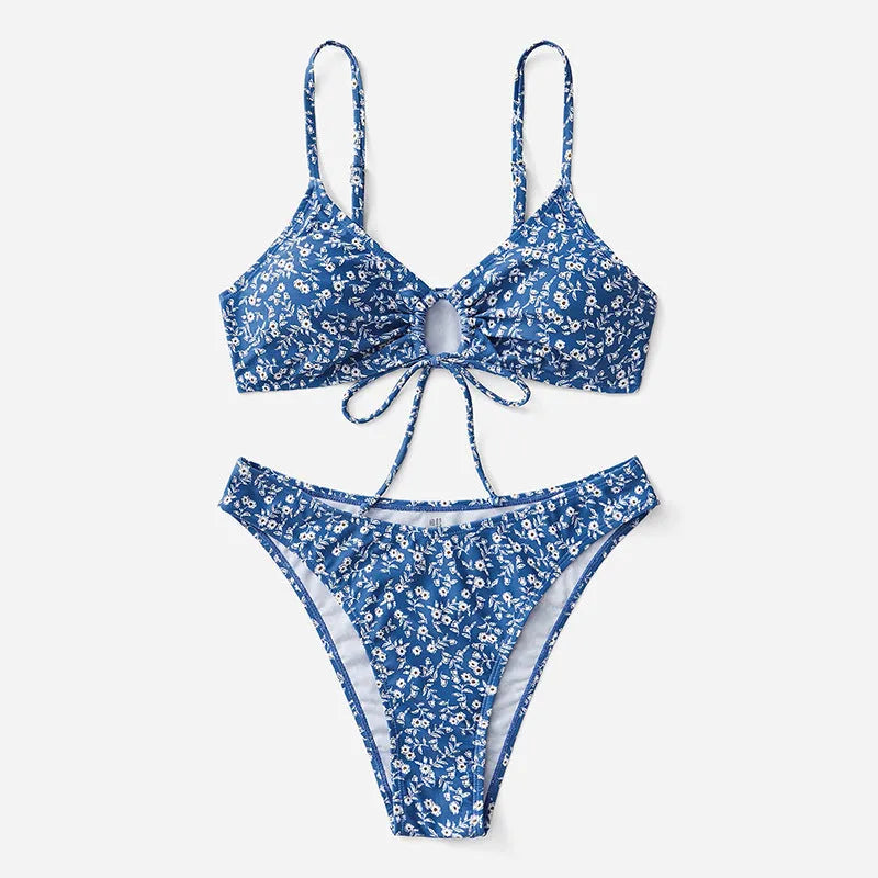 Blue women's three-piece swimsuit set with top and shorts on a white background.