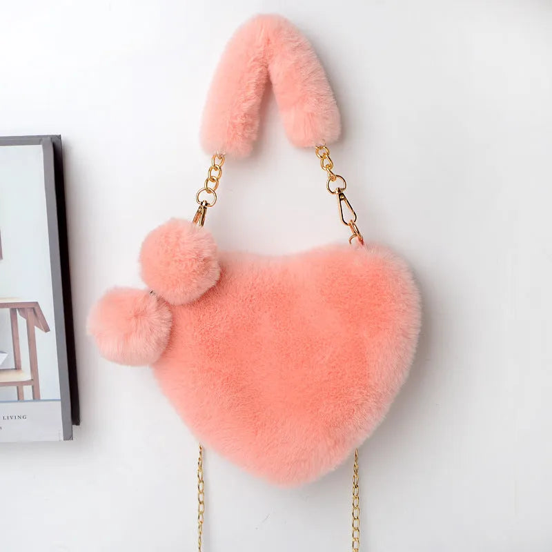 A soft plush heart-shaped women's handbag with a zipper and a detachable shoulder strap in a choice of 14 colours.