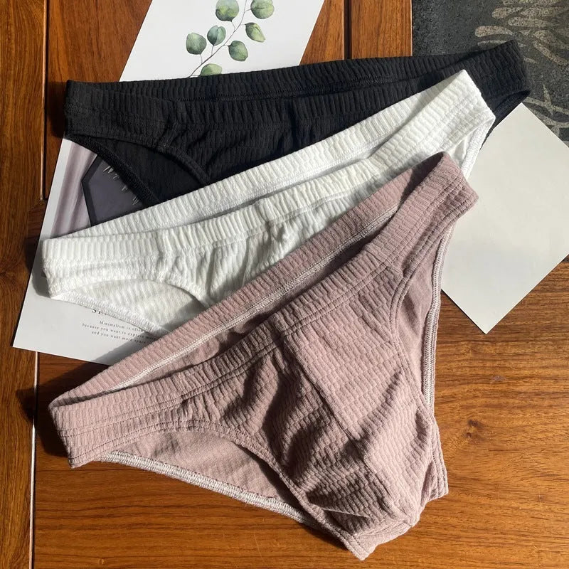 Men's solid colour cotton triangle underwear briefs in mid-waist design on a white background