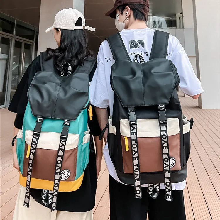 Oxford cloth backpack shown in black, green, or red, featuring multiple carry handles and straps.