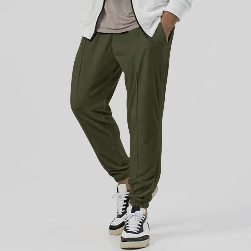 Men's grey loose-fit tapered track sweatpants with a straight leg on a neutral background.