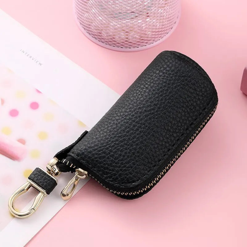 Minimalist black PU leather zippered key case for men, shown closed with a silver zipper.