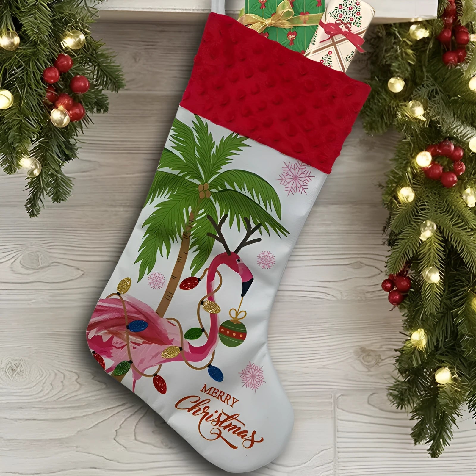 Red and white flamingo print cloth Christmas stocking hanging decoratively.