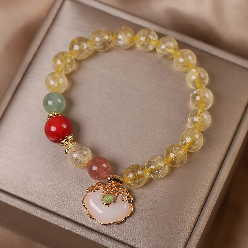 Women's bracelet with a yellow hair crystal jade ruyi pendant on an alloy chain.