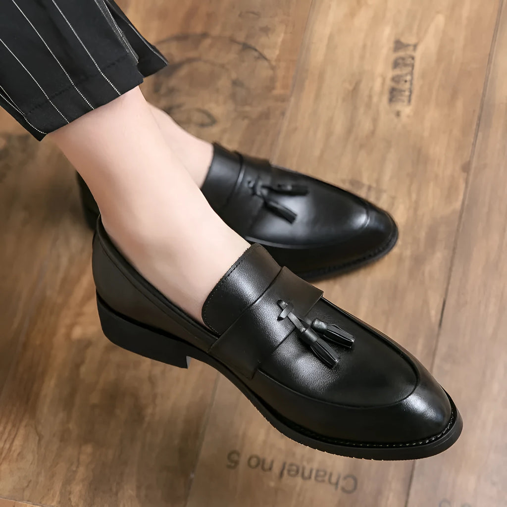 Men's black slip-on business shoes with tassel detail on artificial leather upper