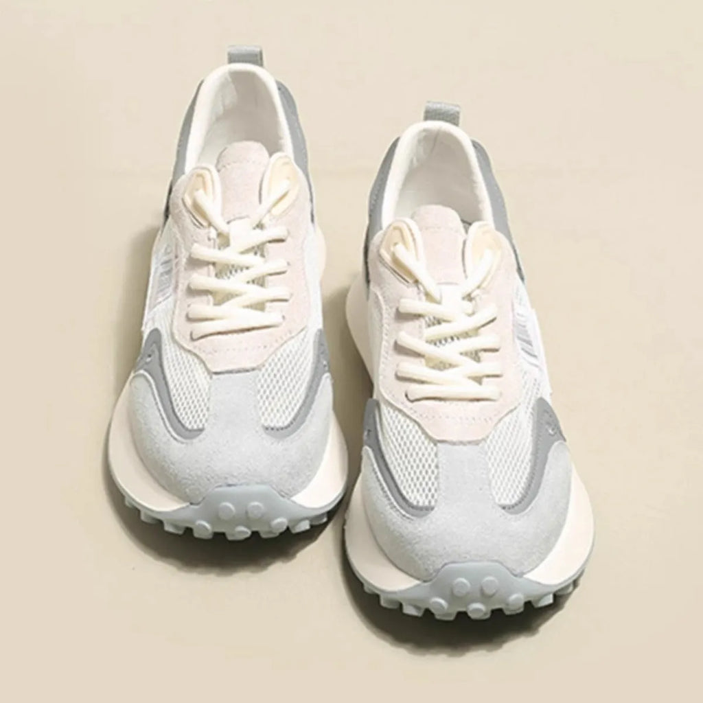 Women's low-top retro sneaker in grey with round toe, rubber sole, and mesh lining.