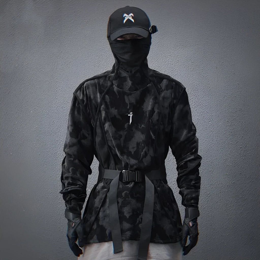 Man modelling a black and grey tie dye finger turtleneck sweater with drop shoulders.