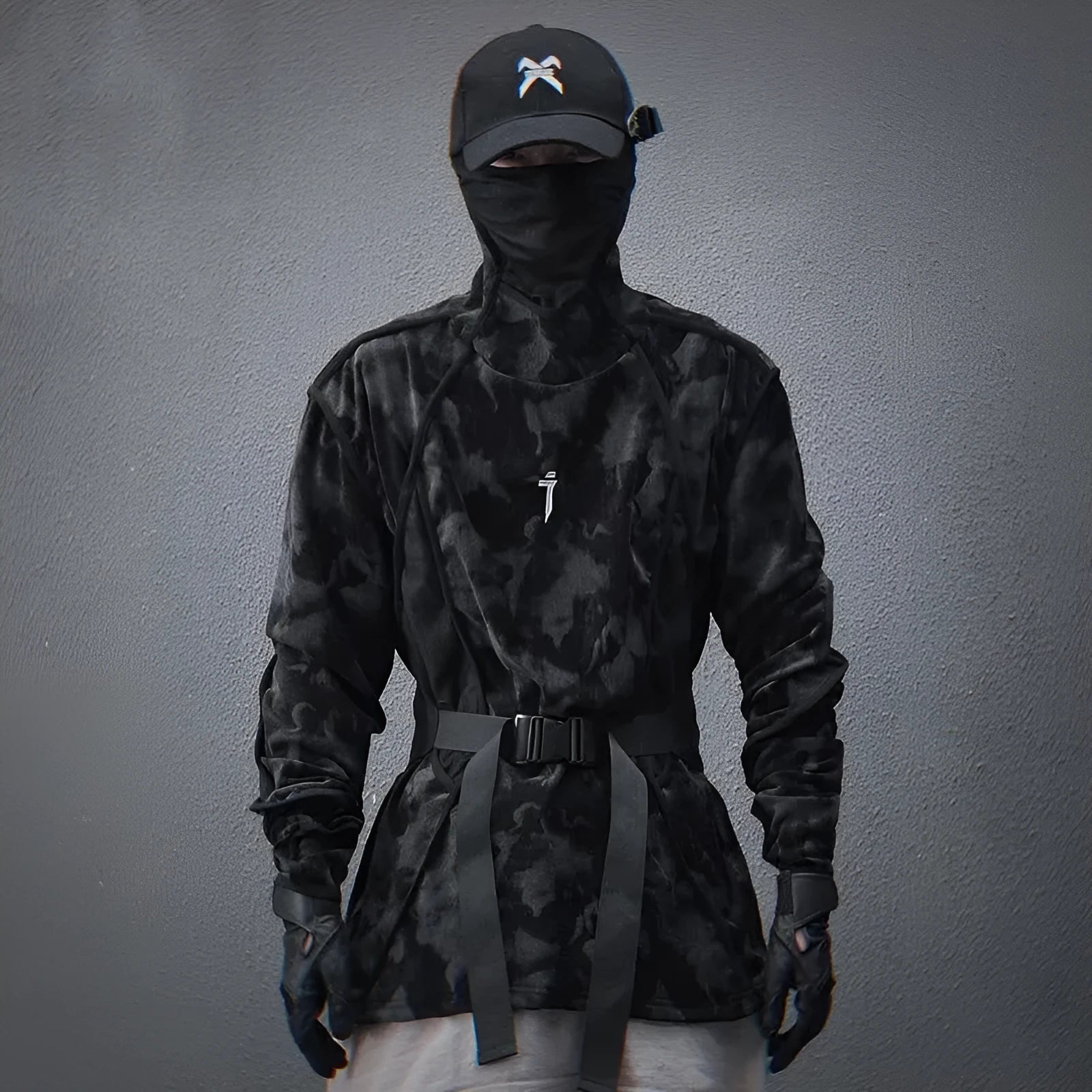 Man modelling a black and grey tie dye finger turtleneck sweater with drop shoulders.