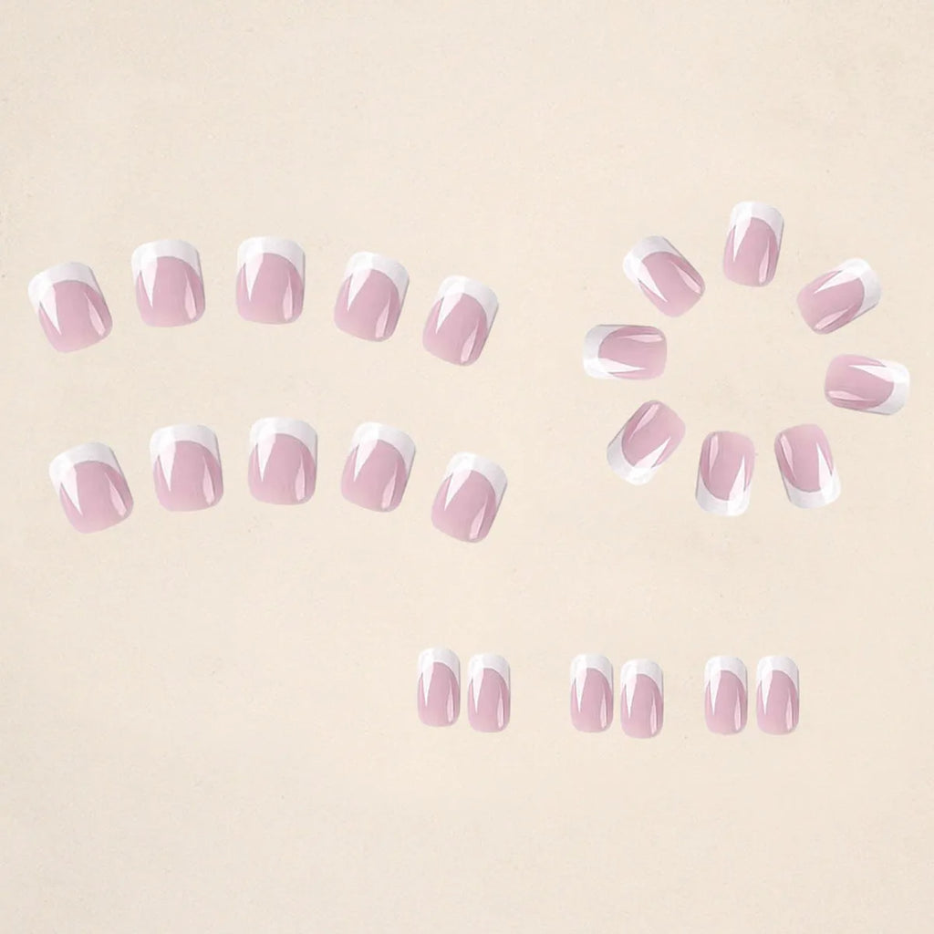 24 white square fake nails with a black and white plaid pattern, laid out on a surface.