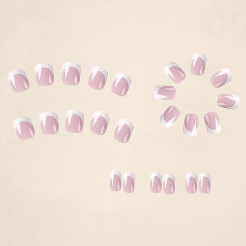 24 white square fake nails with a black and white plaid pattern, laid out on a surface.
