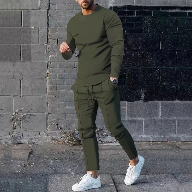Men's light grey polyester two-piece suit with long sleeve round neck T-shirt and matching trousers laid flat.
