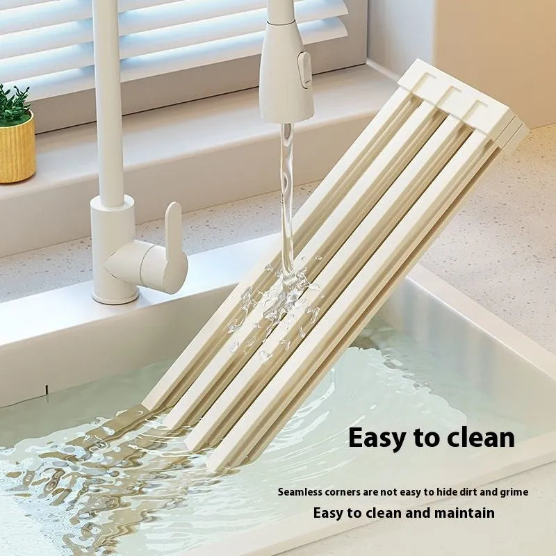Foldable milky white stainless steel kitchen draining rack inside a sink