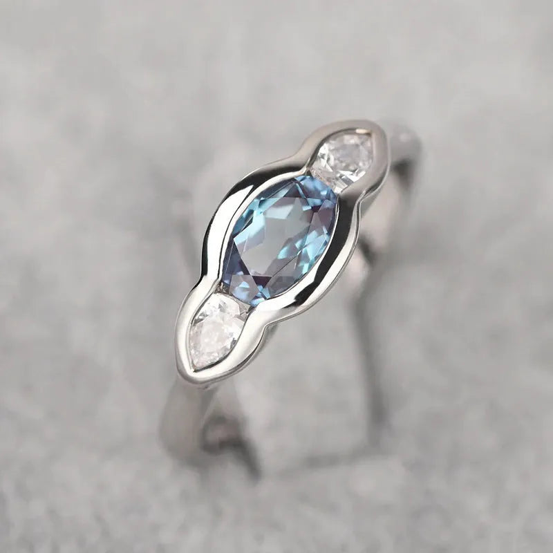Geometric ellipse women's ring with inlaid zircon stones in white gold colour