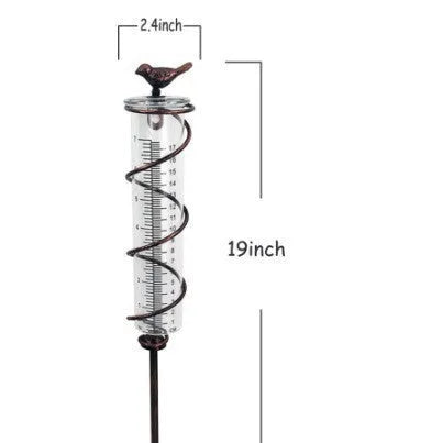 Traditional cast iron bird-shaped hyetometer with glass measurement cylinder showing 800ml capacity