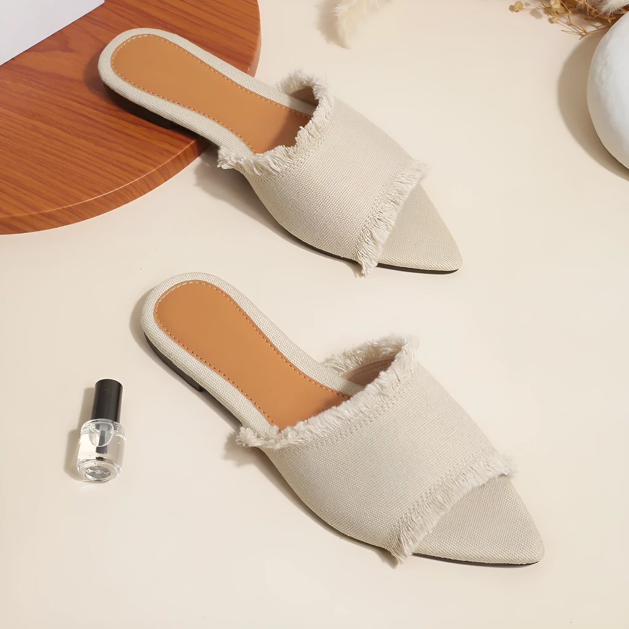 Women's denim flat slippers with tassel detail in multiple colour options showing leather lining and PVC sole
