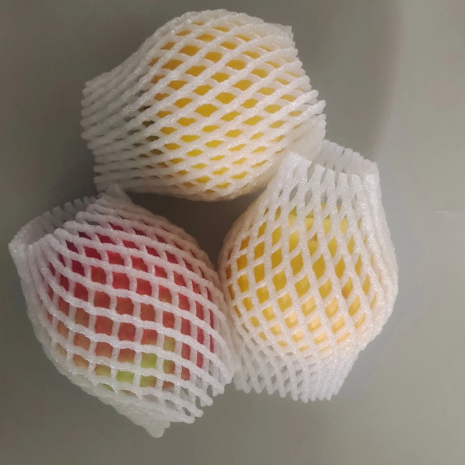 White foam net protective cover shown in various sizes for cushioning fruit and fragile items.